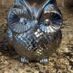Shiny silver color owl figurine.